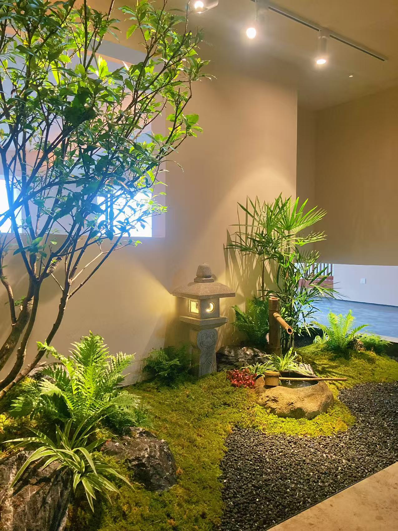 室內日式小庭景以小景石與特黑亮膽石搭配苔面與柔光石燈的配置